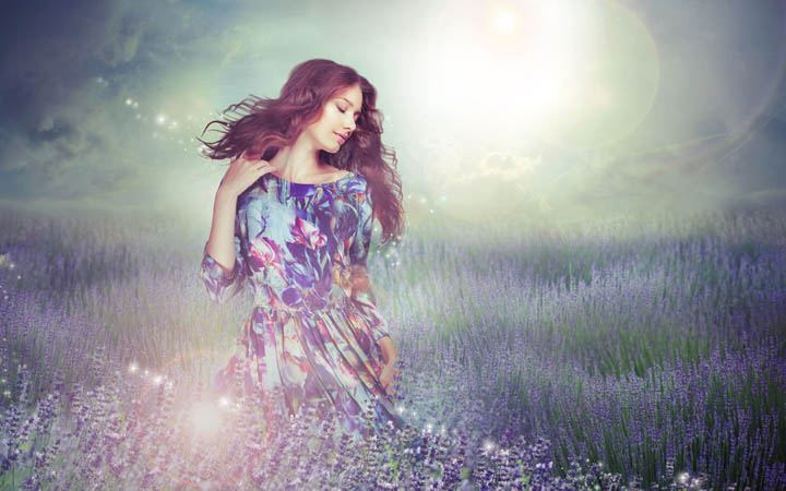 Fantasy. woman in enigmatic meadow over cloudy sky