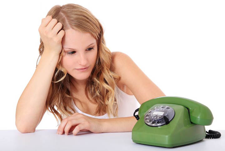 Attractive young woman awaits a phone call. wondering why he hasn't called.