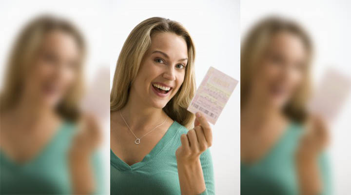 A beautiful woman is holding a lottery ticket symbolizing her odds of finding her Mr. Right.