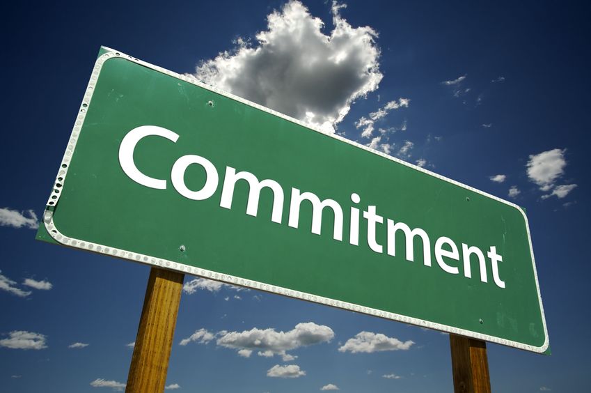 Green freeway sign with Commitment written on it.