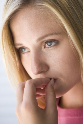 A beautiful blond woman looks fearful, worried that she be forever alone and no one will love her.  