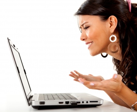 A beautiful woman wondering should I call him looks at a laptop computer screen confused by all of the conflicting dating rules because he hasn't called
