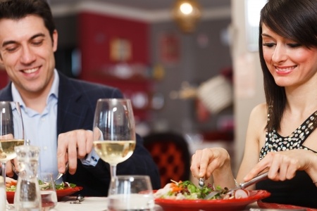 A man and a woman are having what seems to be a romantic formal dinner date but he's sending mixed signals because he says he just wants to be friends.