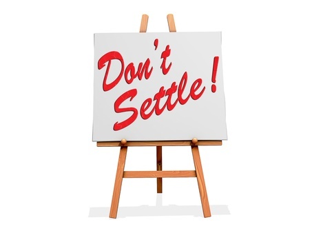 A sign on an easel reads "Don't Settle" referencing the idea of settling for less than what you deserve in a relationship