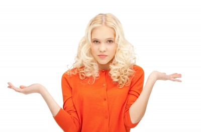 A beautiful woman holds her arms out with palms up, signifying that she has questions about texting, commitment and sex.