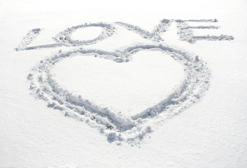 The word love and a heart symbol written in snow.