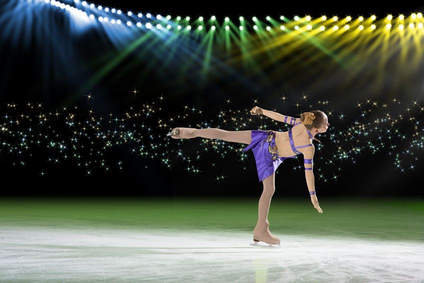 A beautiful young woman is figure skating, building her confidence and enjoying her passion.