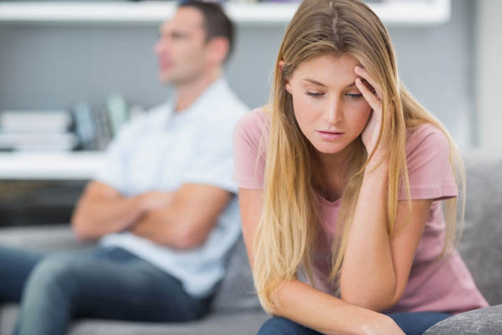 Couple not talking after a fight on the sofa in living room at home