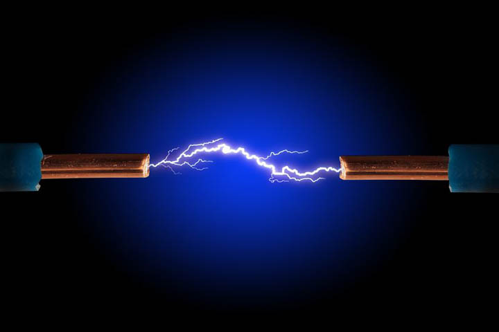 Electric cable with sparks on black background.