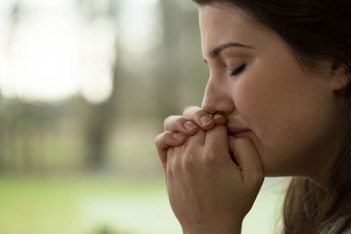 Woman crying over her broken heart, because it hurts so bad.