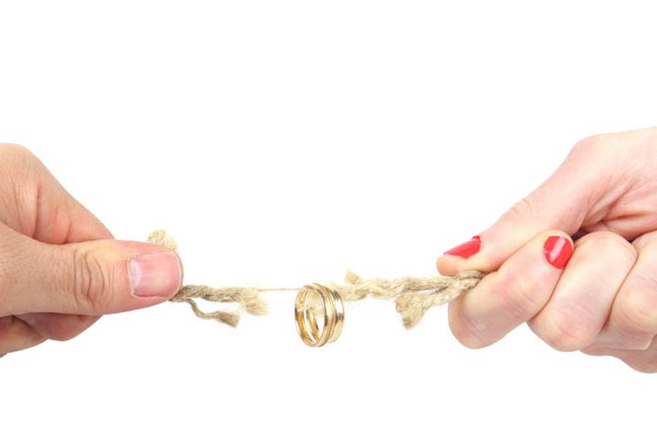 A tug of war between a man and a woman with an engagment ring on a string, signifying non commitment to marriage.