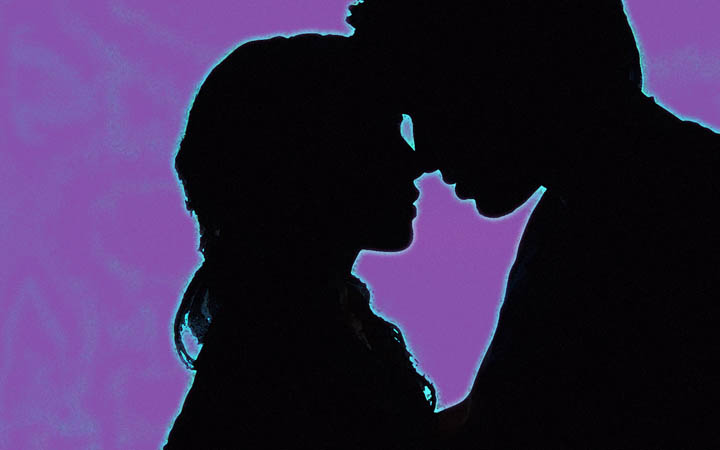 Silhouette of a woman and a man about to kiss, symbolizing love.