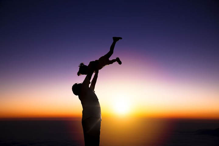 A father plays with his young daughter.