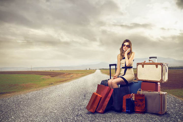 fashionable woman with lots of baggage in the middle of the street